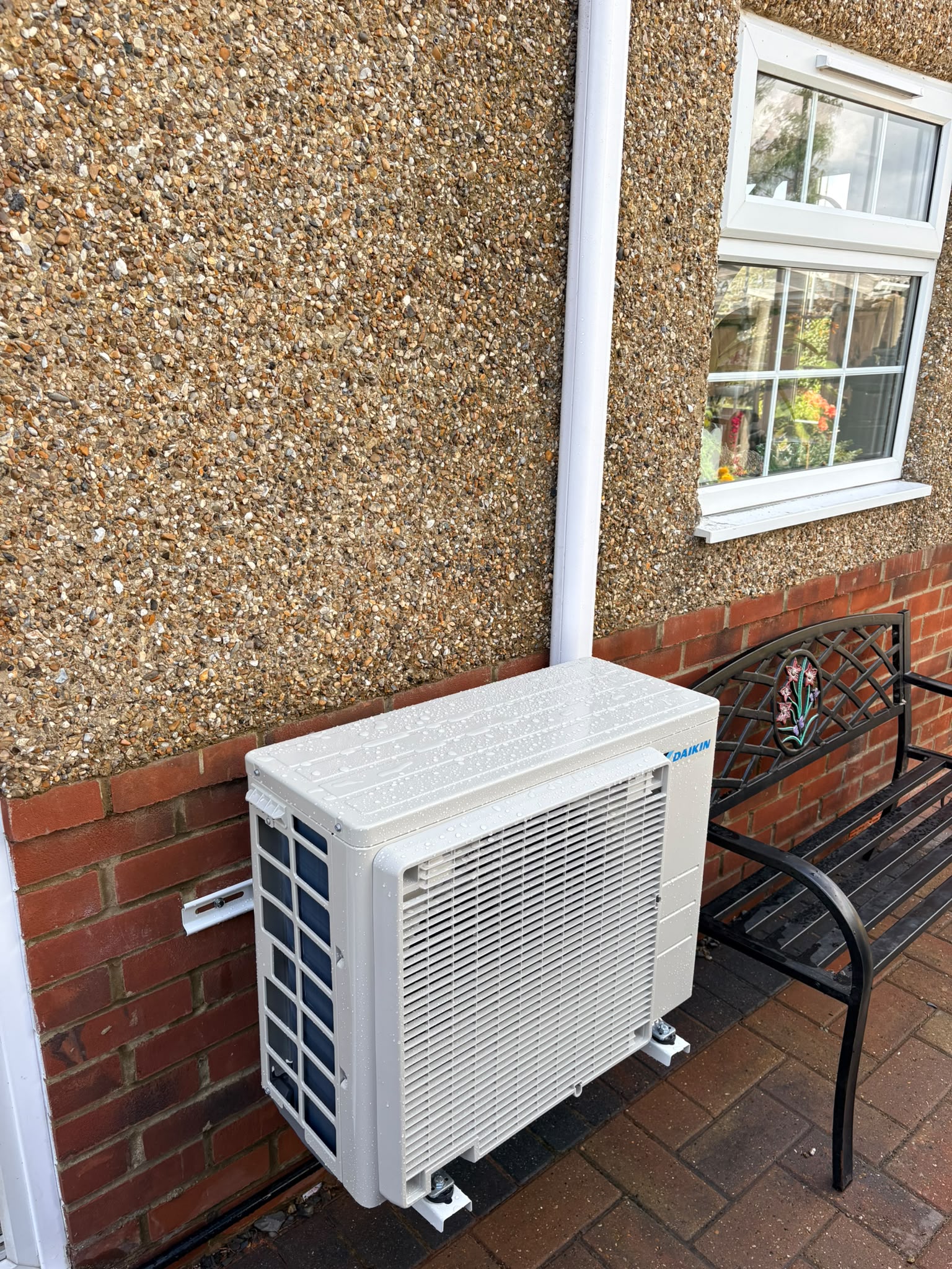 Outdoor unit and trunking following the line of the existing downpipe
